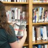 student selecting book in the library