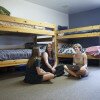 three girls in a dormitory room