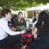 students gathered sitting at a table under tree